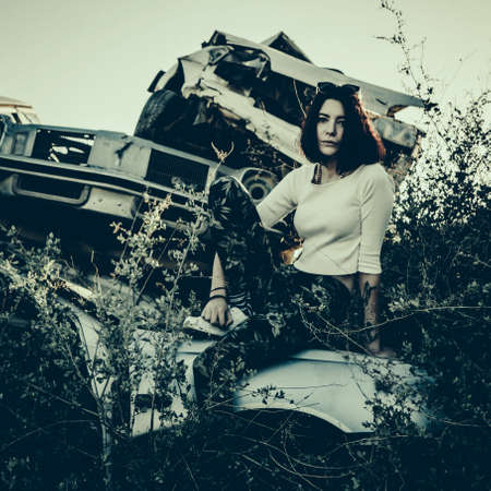 beautiful young girl poses near retro carの写真素材