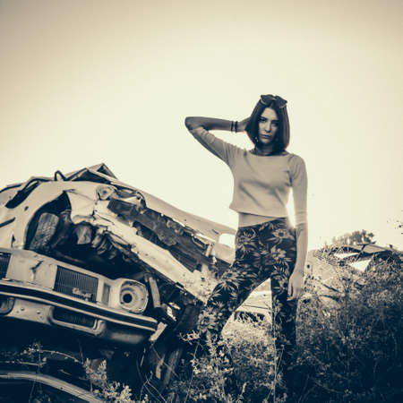 beautiful young girl poses near retro carの写真素材