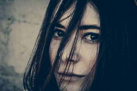beautiful brunette woman with dark eyes portraitの写真素材