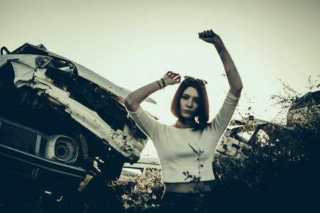 beautiful young girl poses near retro carの写真素材