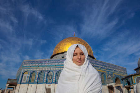 woman standing near Dome of the Rock Mosque near Jerusalemの写真素材