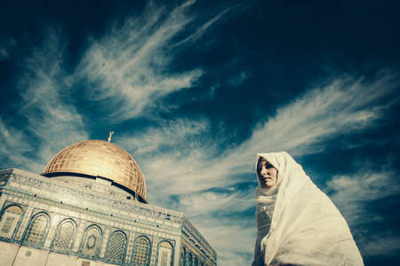 woman standing near Dome of the Rock Mosque near Jerusalemの写真素材