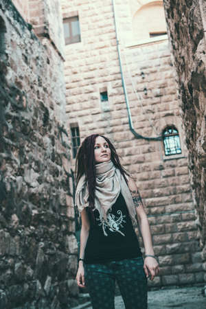 Portrait of a young woman with pink dreadlocks in Old Jerusalemの写真素材
