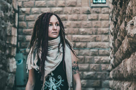 Portrait of a young woman with pink dreadlocks in Old Jerusalemの写真素材