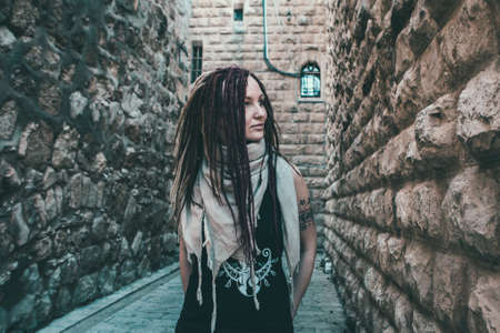 Portrait of a young woman with pink dreadlocks in Old Jerusalemの写真素材
