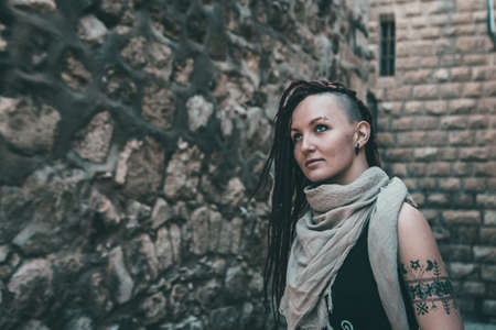 Portrait of a young woman with pink dreadlocks in Old Jerusalem