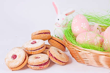 Easter eggs and rabbit with cake on white background
