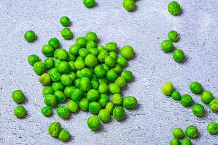 Fresh green peas on blue concrete table  backgroundの写真素材