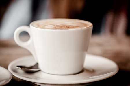 cup of cappuccino over wooden table