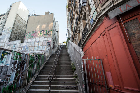 PARIS- October 6, 2016: People climbing the long ascent up steep stairs to visit Sacre Coeur, the Catholic church and popular landmark located at the summit of Montmartre, the highest point in the city.のeditorial素材