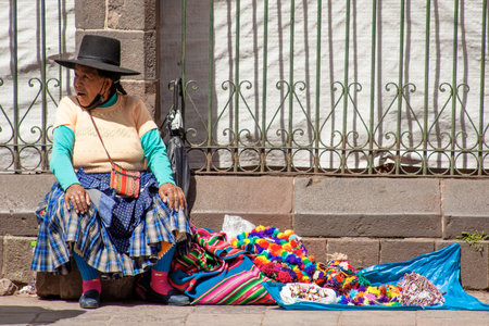 PERU - MAY 15, 2022: Peruvian people in traditional clothes in Cuzco. Woman selling on the street in Cusco, Peru, May 15, 2022のeditorial素材