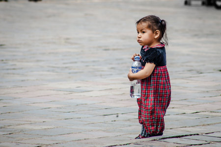 PERU - MAY 15, 2022: Peruvian people in traditional clothes in Cuzco. Small girl on the street. Cusco, Peru, May 15, 2022のeditorial素材