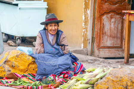 PERU - MAY 5, 2022: Peruvian people in traditional clothes in Ollataytambo. Woman selling on the street in Ollataytambo, Peru, May 5, 2022のeditorial素材