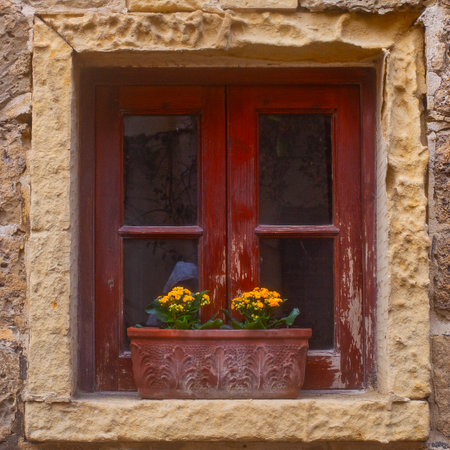 Window with kalanhoe flowerpot on the Narrow street of ancient city Rabat with traditional maltese houses built of limestone, Victoria, Maltaの写真素材