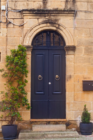 Victoria (Rabat), Malta - February 23, 2024: Narrow street of ancient city Rabat with traditional Maltese houses built of limestone, Victoria, Maltaの写真素材