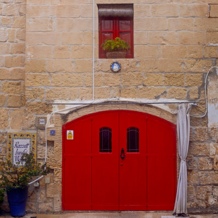Victoria (Rabat), Malta -  Febtuary 23, 2024: Narrow street of ancient city Rabat with traditional maltese houses built of limestone, Victoria, Maltaの写真素材