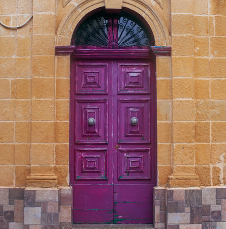 Violet doors on the Narrow street of ancient city Rabat with traditional maltese houses built of limestone, Victoria, Maltaの写真素材