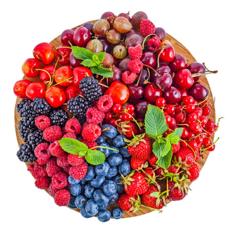 Fresh summer berries assortment on the round plateの写真素材