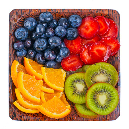 Fruits and berries on the wooden plateの写真素材