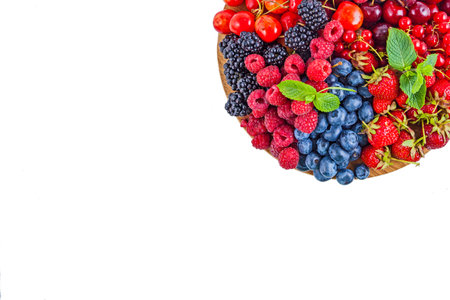 Fresh summer berries assortment on the round plateの写真素材