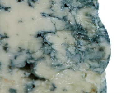 Wedge of soft blue cheese  in green box with mold isolated on white background.の写真素材