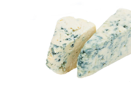 Wedge of soft blue cheese with mold isolated on white background.の写真素材