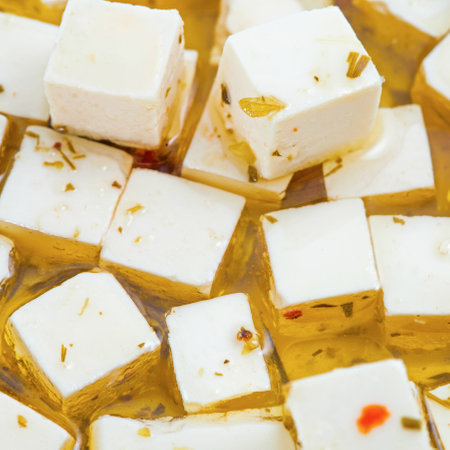 Feta cheese in oil with spicesの写真素材