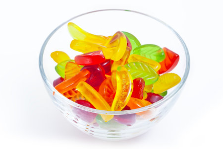 Fruit jelly candies in glass bowl on the white backgroundの写真素材