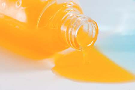 Spilled bottles of colorful shampoo, on whiteの写真素材