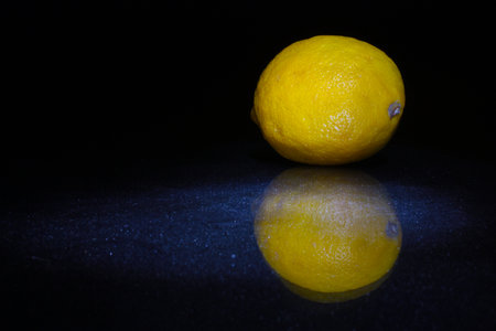 fresh lemons on the black background with water dropsの写真素材