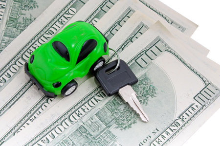 Toy car, keys and money isolated on white backgroundの写真素材