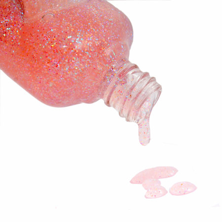 Bottle of pink nail polish and drop samples, isolated on whiteの写真素材