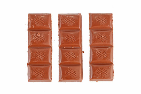 Broken chocolate bar on a white backgroundの写真素材