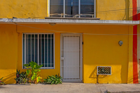 Colorful yellow colonial style buildings at street of Merida city old town, Mexicoの写真素材