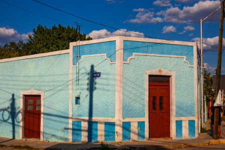 Merida, Yucatan, Mexico - 4 April, 2022: Street of Merida, Small bright light blue  colonial house with shadowsの写真素材