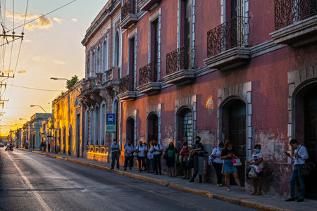 Merida, Yucatan, Mexico - 4 April, 2022: Old street of Merida downtown, colonial style building at sunsetの写真素材