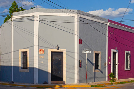 Merida, Yucatan, Mexico - 4 April, 2022: Small pastel colored colonial house with a washed out facadeの写真素材