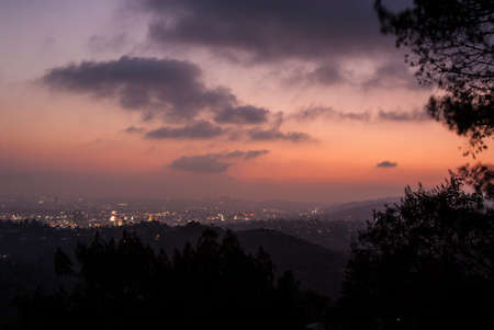 A pink sunset with gray clouds sets over Los Angeles.の写真素材