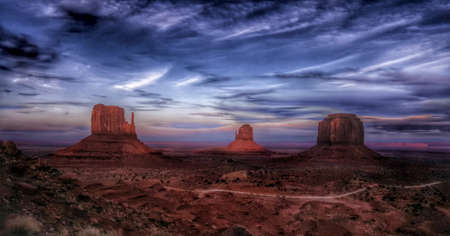 Monument Valley in Arizona under a cloudscape at dusk.の写真素材