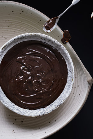 Chocolate ganache being stirred in a bowlの写真素材