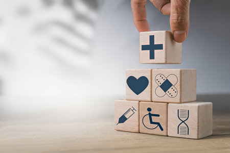Hand holding wooden block with icon healthcare medical with copy spaceの写真素材