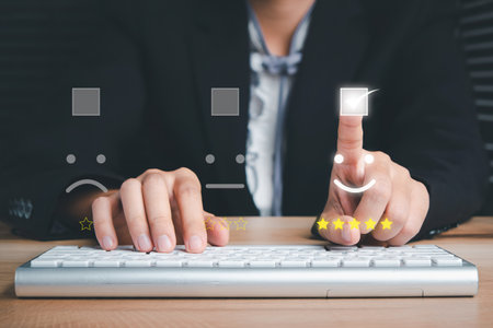 Business woman finger pointing smiley face emoticon on virtual touch screen.good feedback ratingの写真素材