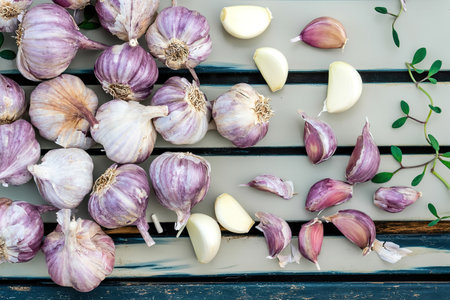 Garlic cloves on wooden vintage background. Seedlings for planting garlicの写真素材