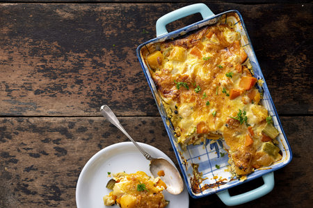 Vegetable gratin with sweet potato, celery, parsnip, carrot, cheese and eggsの写真素材