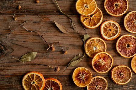 top view of dried orange slices arranged on wooden background with copy spaceの写真素材