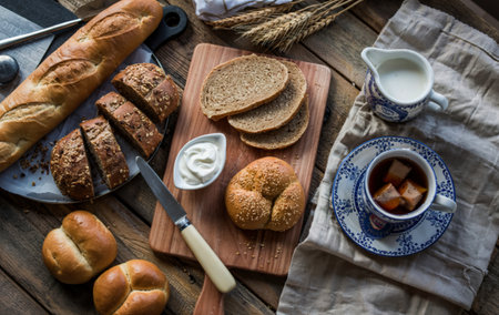 top view of breakfast set with breads as sliced rye white ones and flatbread on cutting board