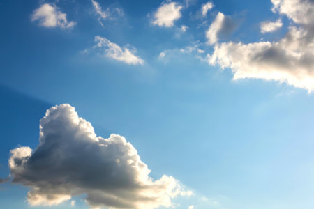 A large cumulus cloud dominates the lower left corner of the image, set against a backdrop of a...