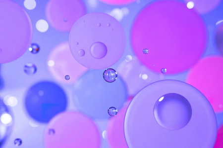 A captivating image showcasing vibrant pastel-colored oil and water bubbles of varying sizes,...