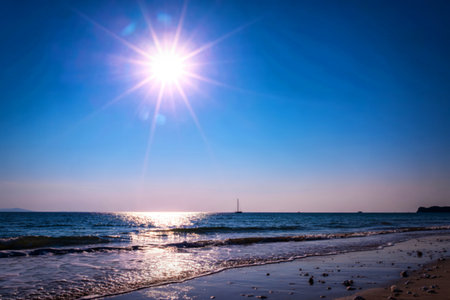 Bright sun shining over calm ocean beachの写真素材