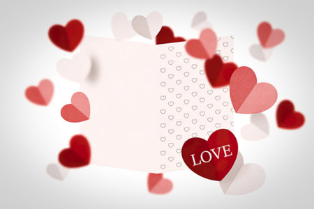 A light pink gift box opens to reveal a pattern of small hearts, with numerous red and pink paper hearts floating around it, creating a festive and romantic atmosphere.の写真素材